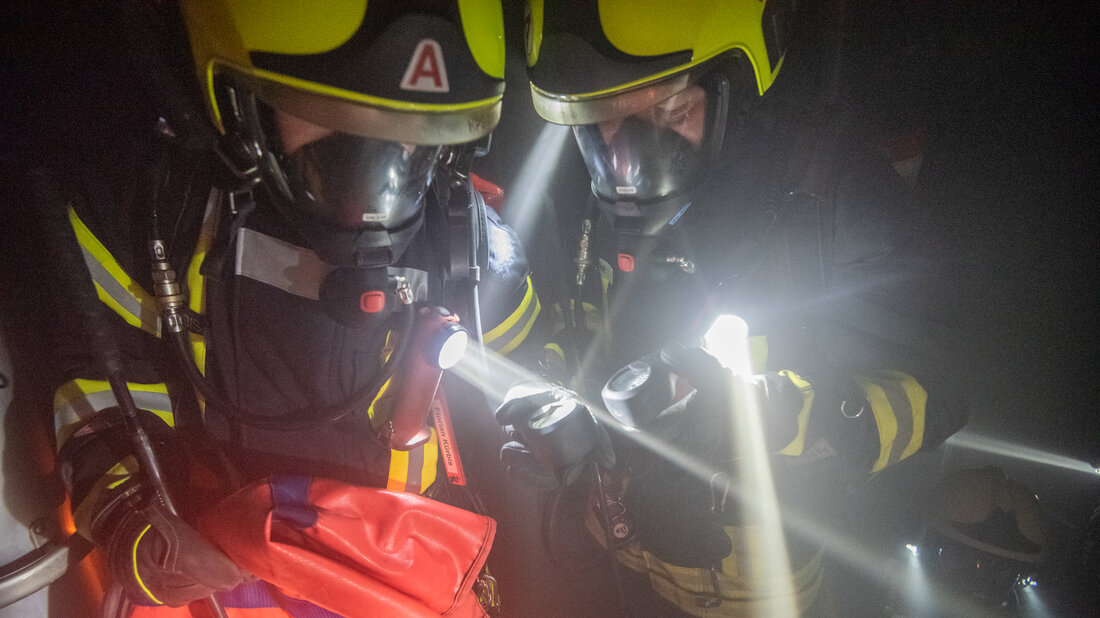 Emergency personnel compare the remaining pressure of their breathing apparatus.