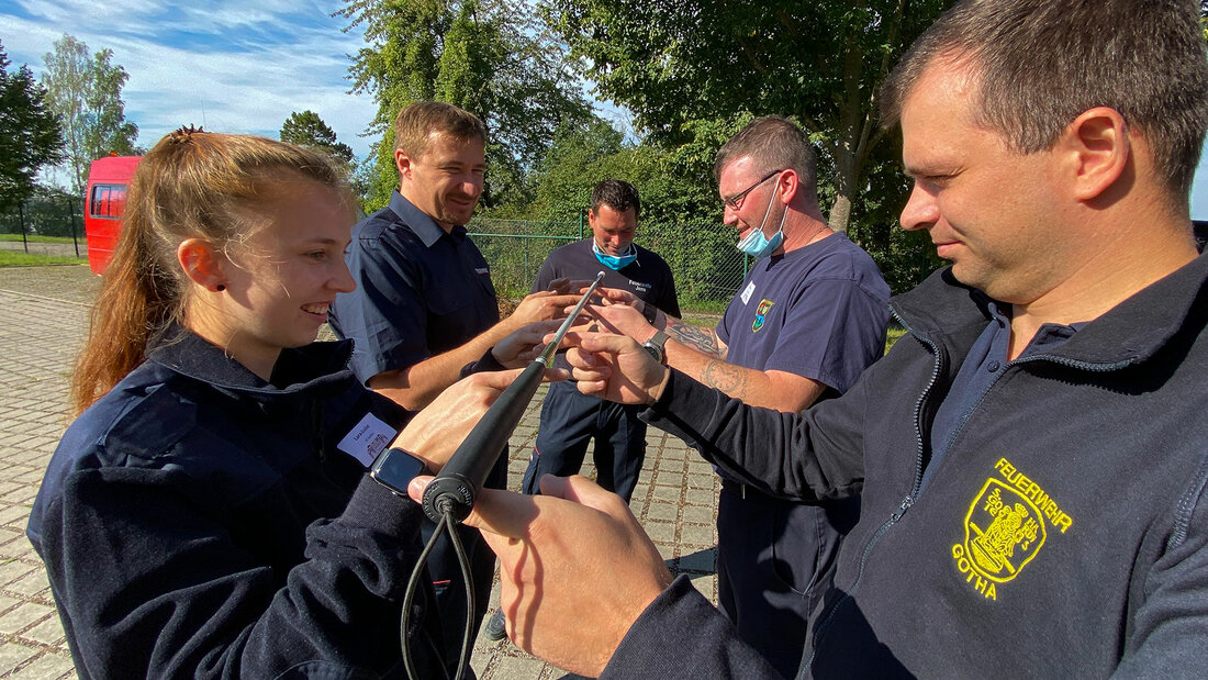 Firefighters balance a search stick on their index fingers to train their coordination