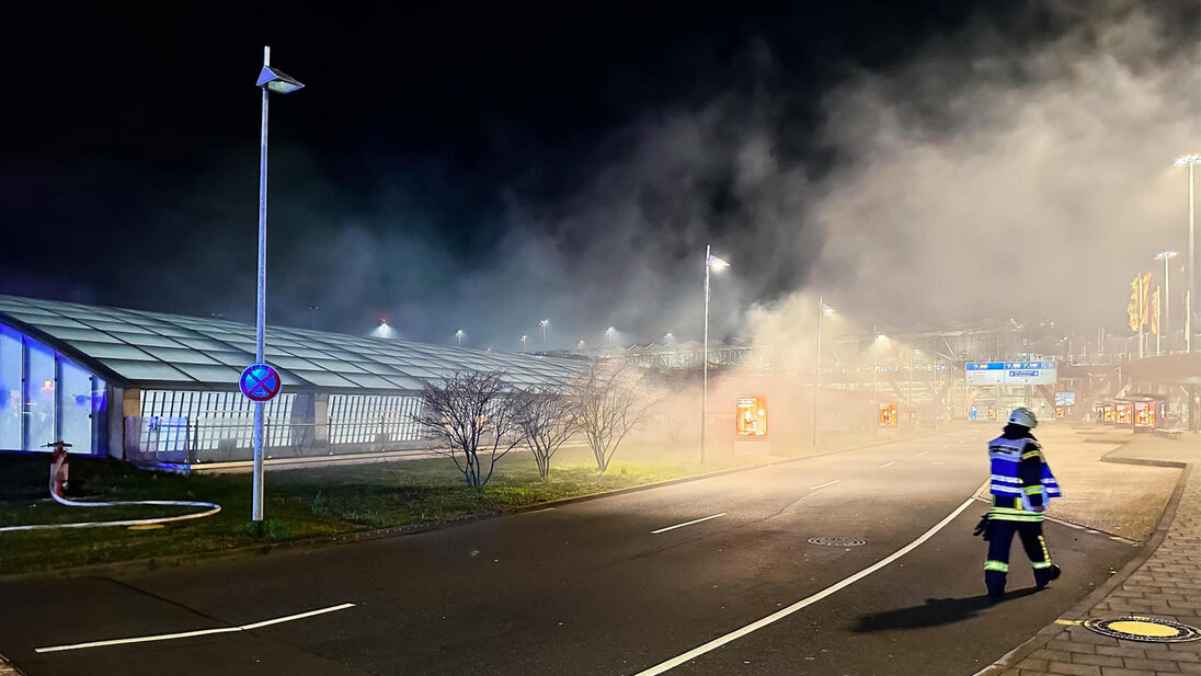 Smoke billows out of the domed roof of the Cologne/Bonn airport railway station.