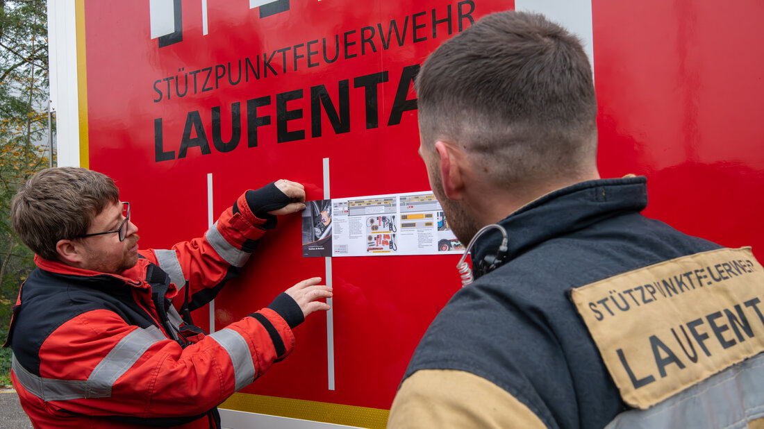 Feuerwehrangehörige nutzen Merkblätter beim Üben am Standort