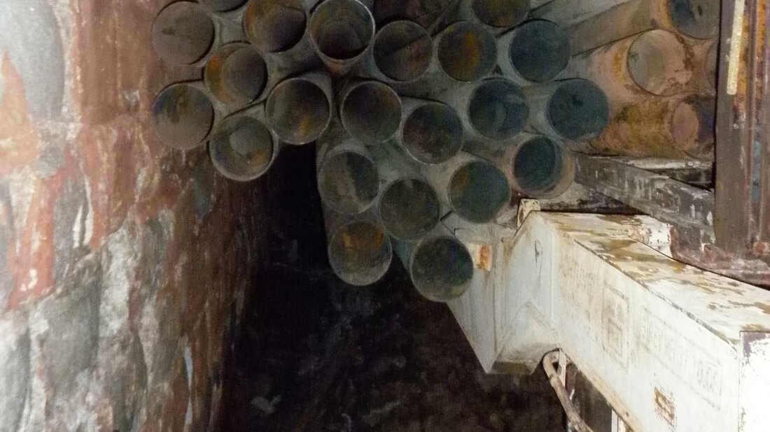 Freight wagon with partially fallen load due to a fire in a railway tunnel