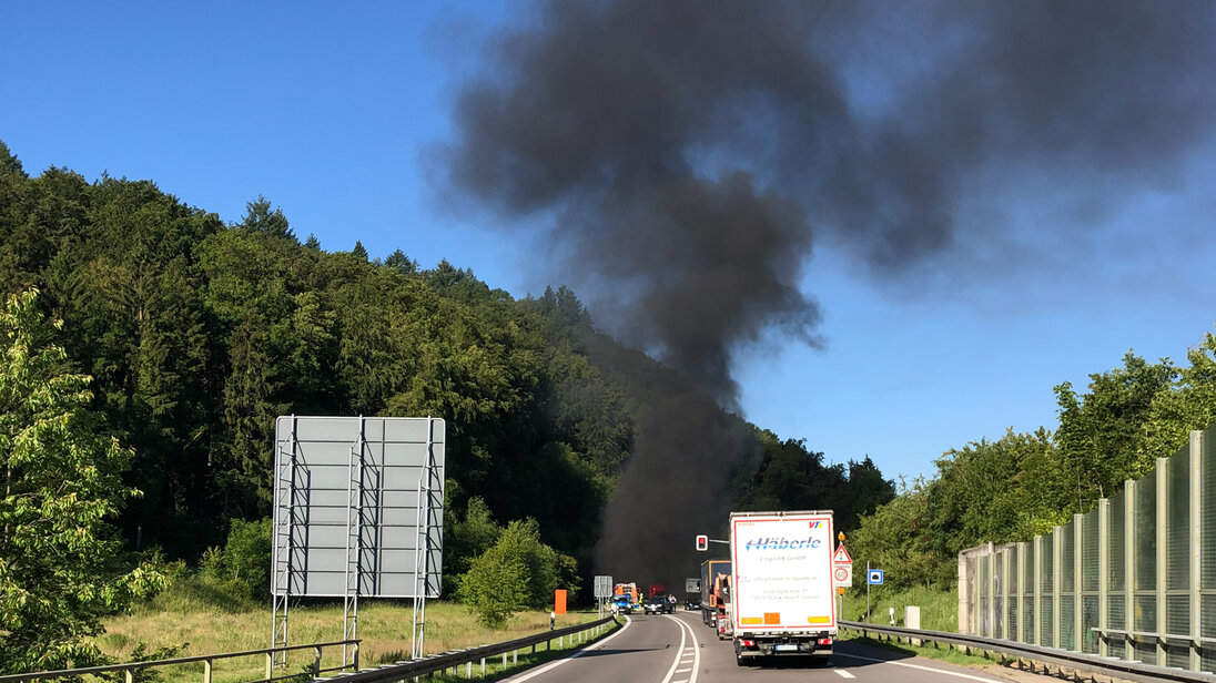 Black smoke emanates from a tunnel portal